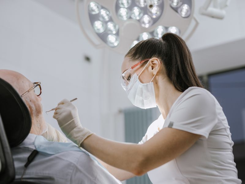 Dentist examining patient at Hope Essence Dental Clinic
